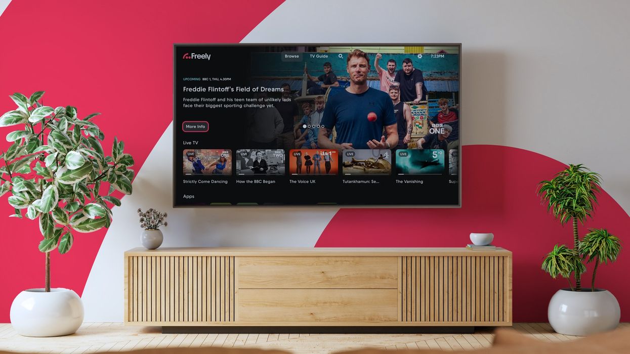 Freely logo pictured on a wall of a living room with a flatscreen smart tv mounted on the wall with the new freely features shown on-screen