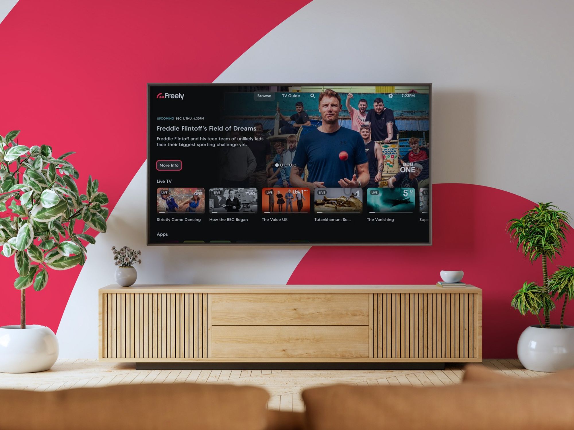 Freely logo pictured on a wall of a living room with a flatscreen smart tv mounted on the wall with the new freely features shown on-screen