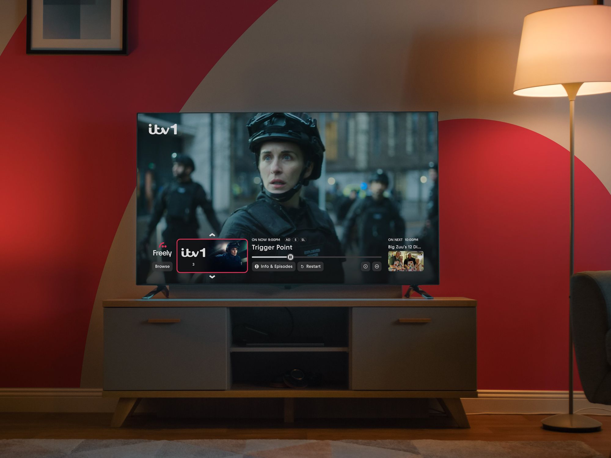 Freely TV on the Mini Guide interface pictures on-screen with the Freely logo in the background