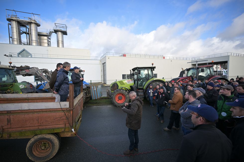 French farmers take part in a rally in front of a dairy products factory