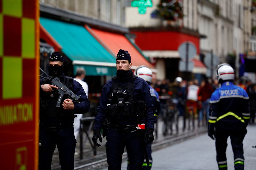 French police and firefighters secure a street after gunshots were fired killing two people and injuring several in a central district of Paris, France, December 23, 2022. REUTERS/Sarah Meyssonnier