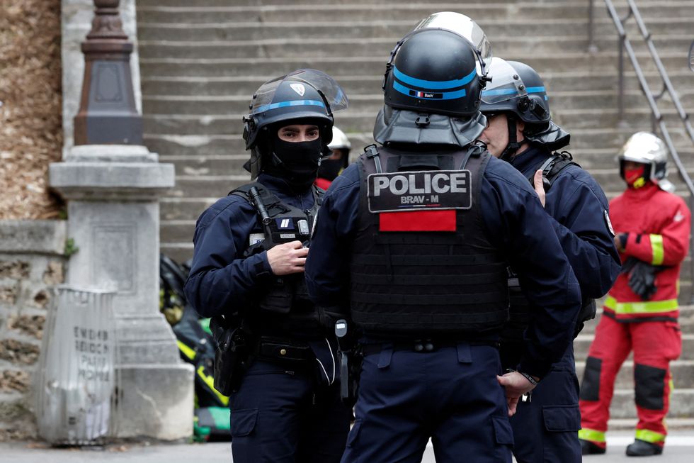 French police and firefighters secure the area near Iran consulate where a man is threatening to blow himself up