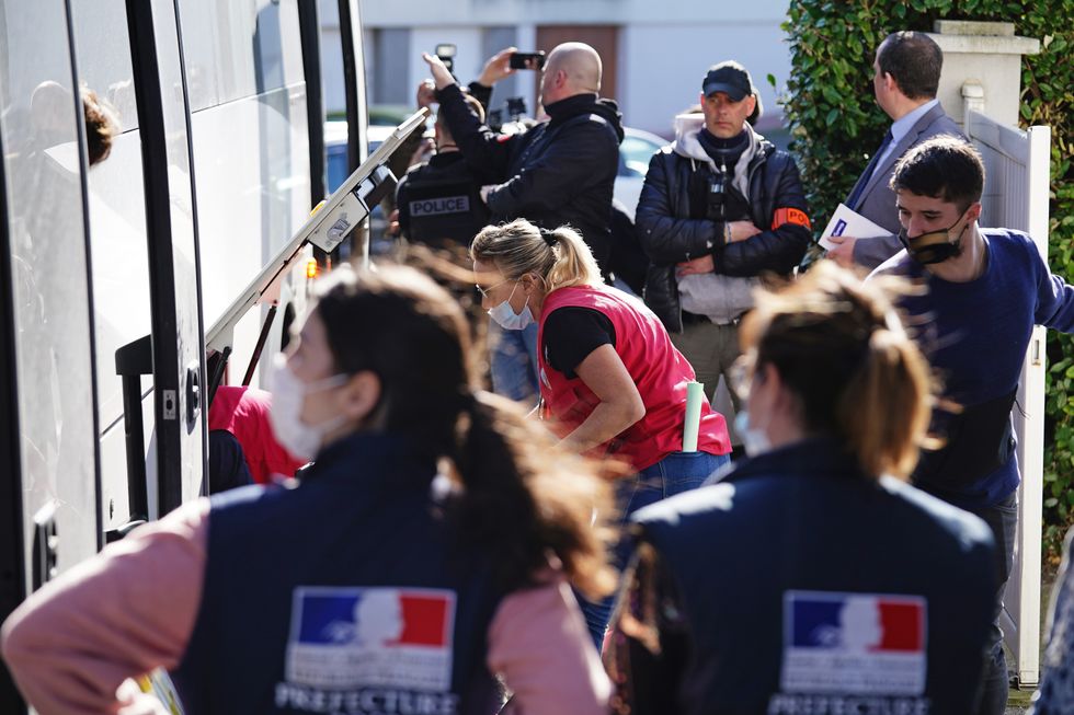 French police block the view of Ukrainian refugees loading their belongings onto a bus before it departs from the Centre Europeen de Sejours youth hostel in Calais, France, where they have been accommodated before onward travel to other areas. Picture date: Wednesday March 9, 2022.