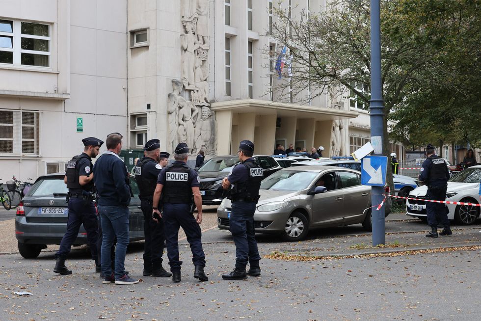 French police officers stand in front of the Gambetta high school in Arras,