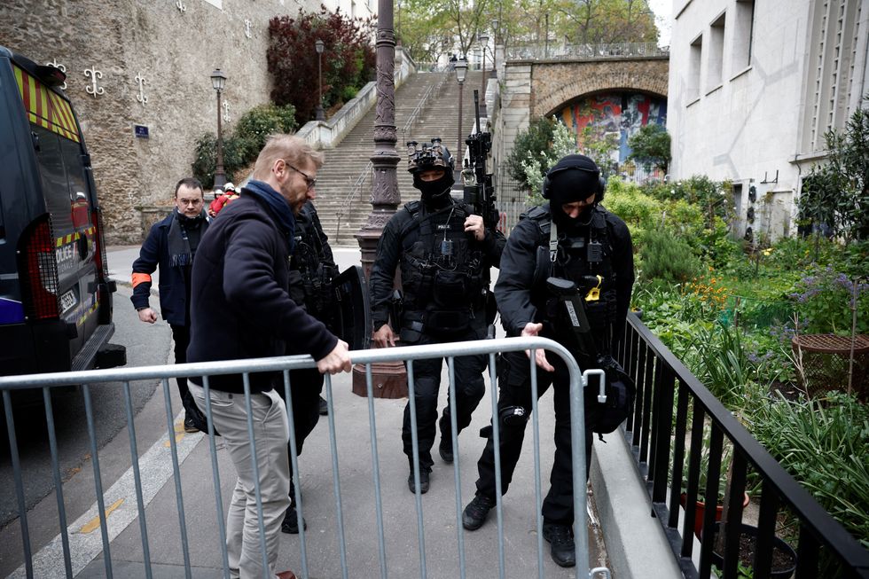 French police secure the area near Iran consulate after a man had threatened to blow himself up