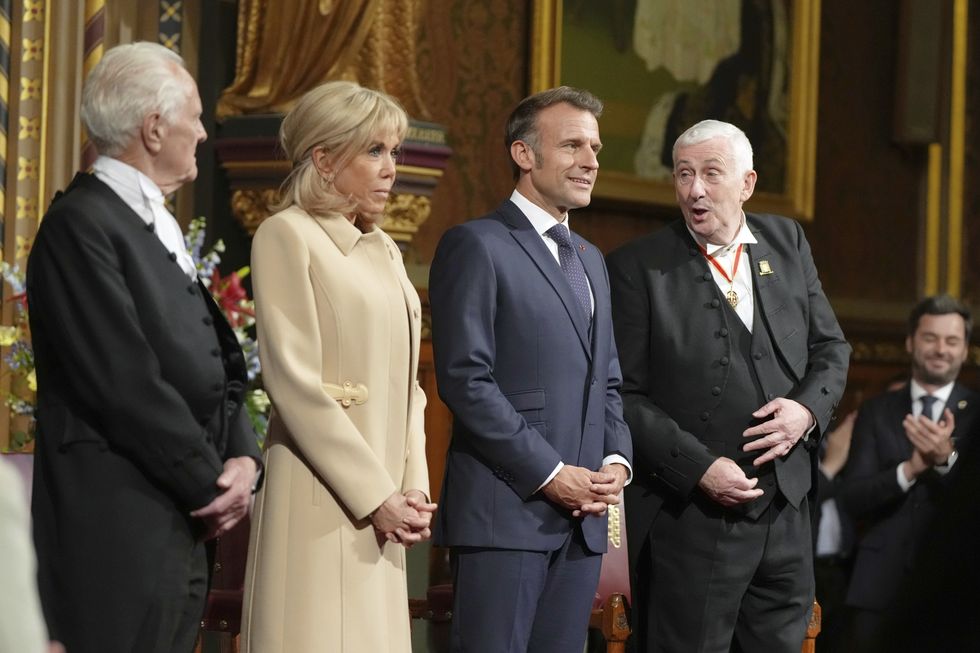 French President Emmanuel Macron and his wife Brigitte stand beside the Speaker of the House of Commons Lindsay Hoyle (right), before addressing MPs and peers in the Royal Gallery at the Palace of Westminster