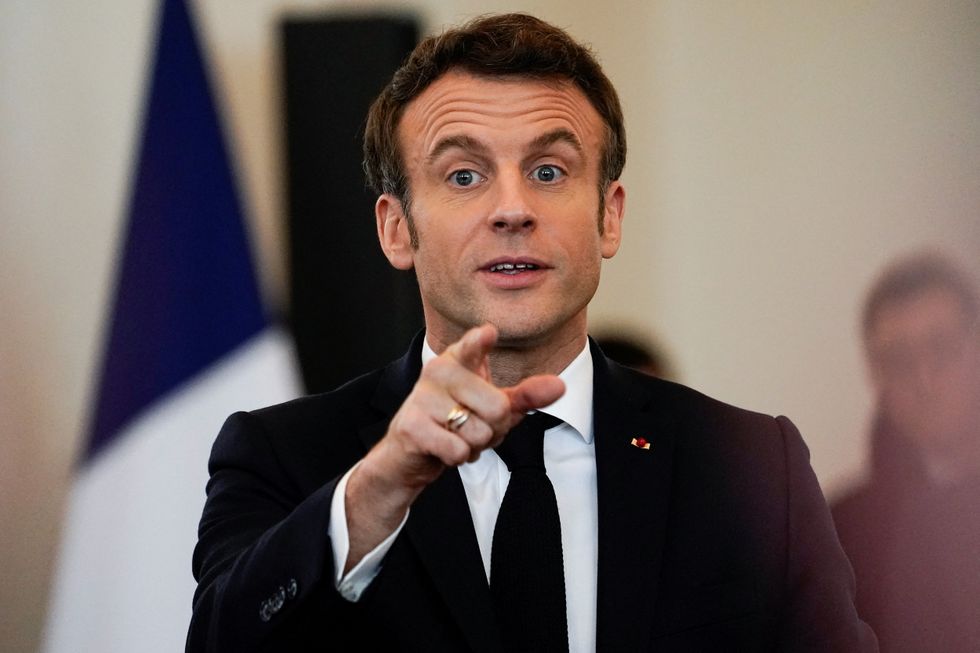 French President Emmanuel Macron, candidate for his re-election in the 2022 French presidential election, speaks during a campaign meeting with local residents in Pau, France, March 18, 2022. REUTERS/Vincent West