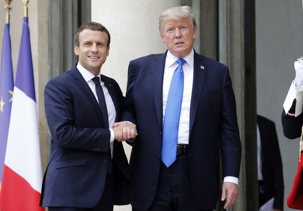 French President Emmanuel Macron welcomes former US President Donald Trump prior to a meeting at the Elysee Presidential Palace