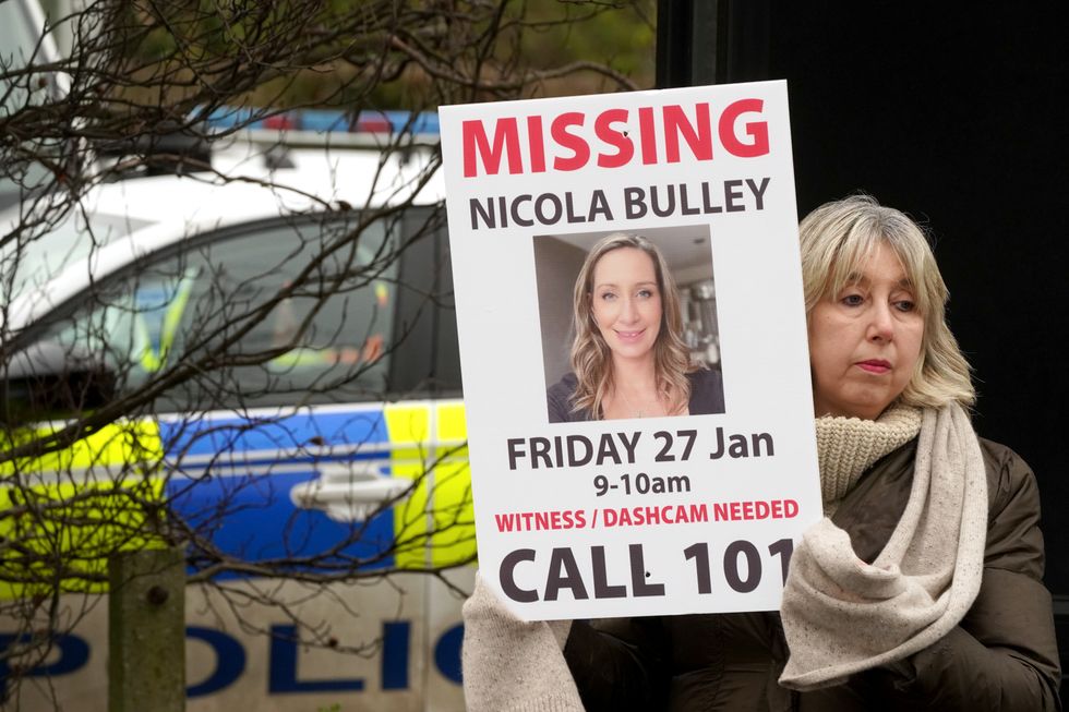 Friends of missing woman Nicola Bulley hold missing person appeal posters along the main road in the village in St Michael's on Wyre, Lancashire. Ms Bulley, 45, was last seen two weeks ago on the morning of Friday January 27, when she was spotted walking her dog on a footpath by the nearby River Wyre. Picture date: Friday February 10, 2023.