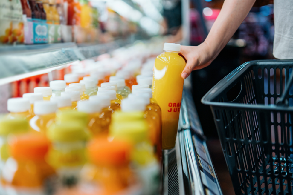 Fruit juices lined up along a supermarket shelf