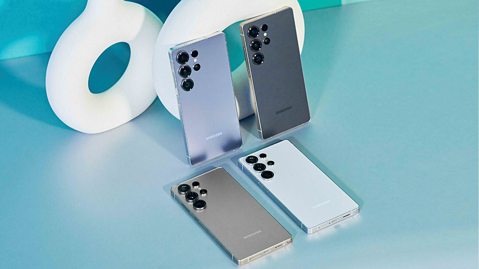 galaxy s25, galaxy s25 plus and galaxy s25 ultra pictured lying on a blue table next to one another 