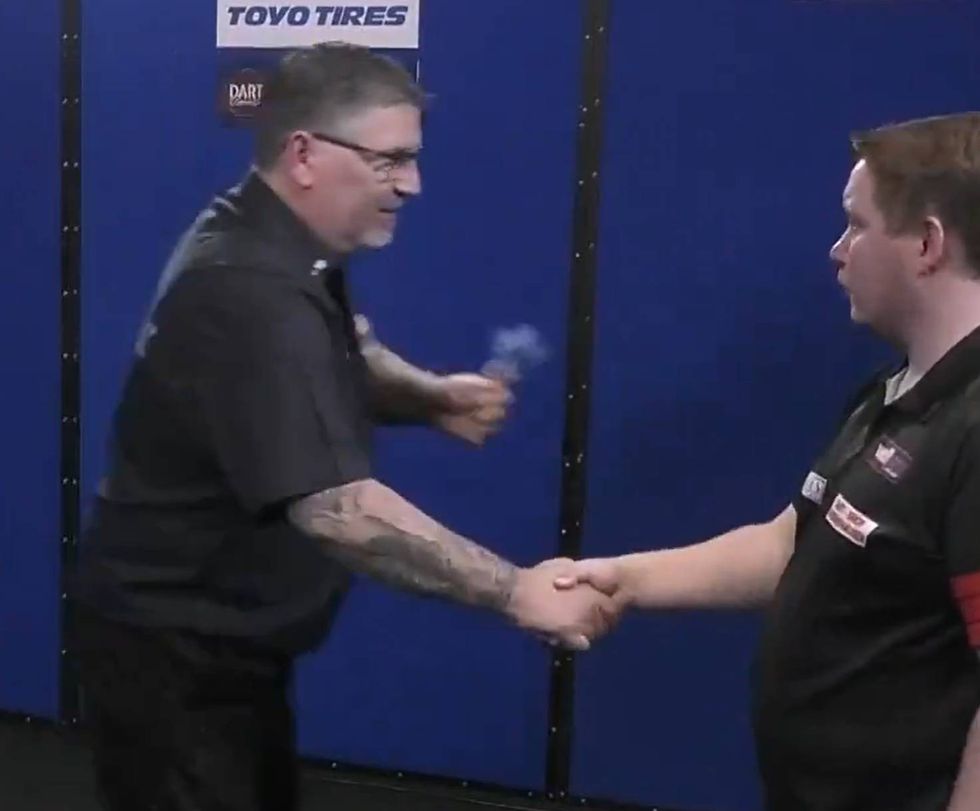 Gary Anderson shook hands with a confused Martin Schindler