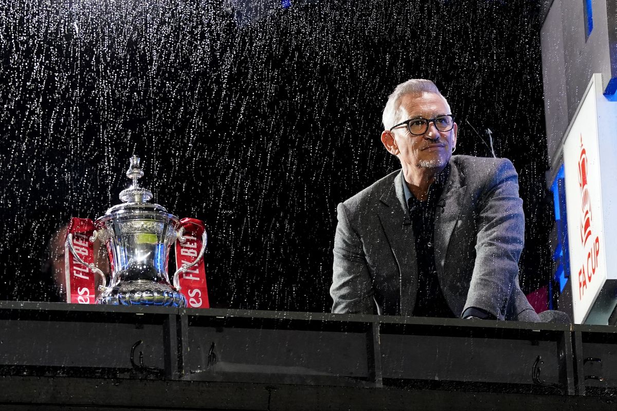 Gary Lineker next to the FA Cup trophy