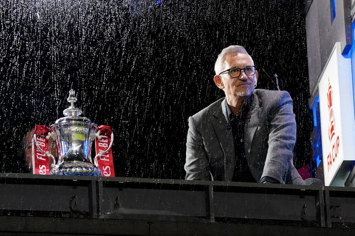 Gary Lineker next to the FA Cup trophy
