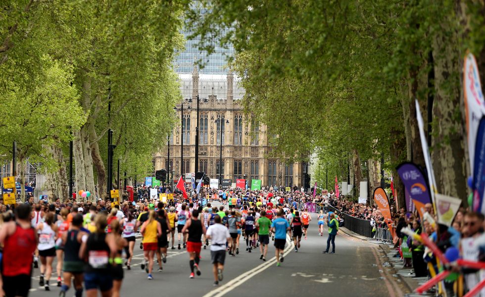 General view of runners as they pass the Palace of Westminster during the 2019 Virgin Money London Marathon.