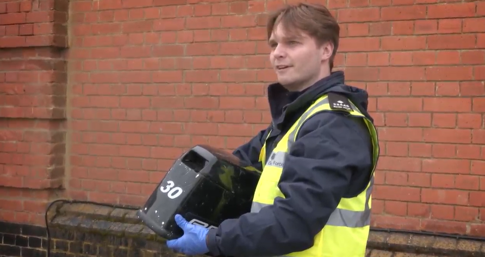 George Stevenson holding an outboard motor