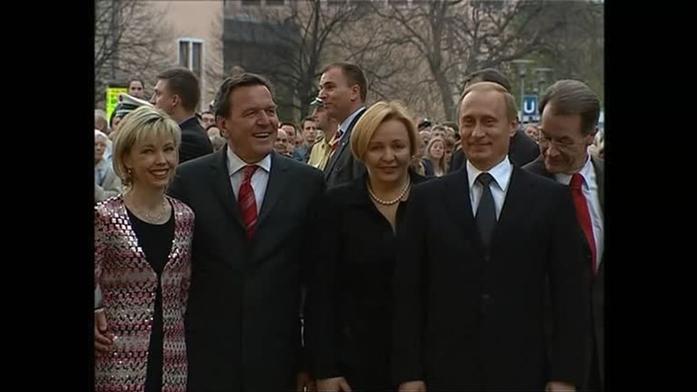 Gerhard Schroeder (second from left) with Vladimir Putin