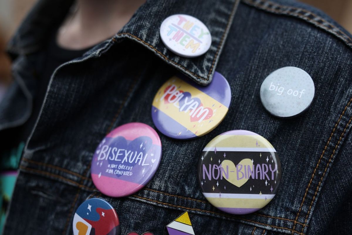 Girl with LGBT badges 