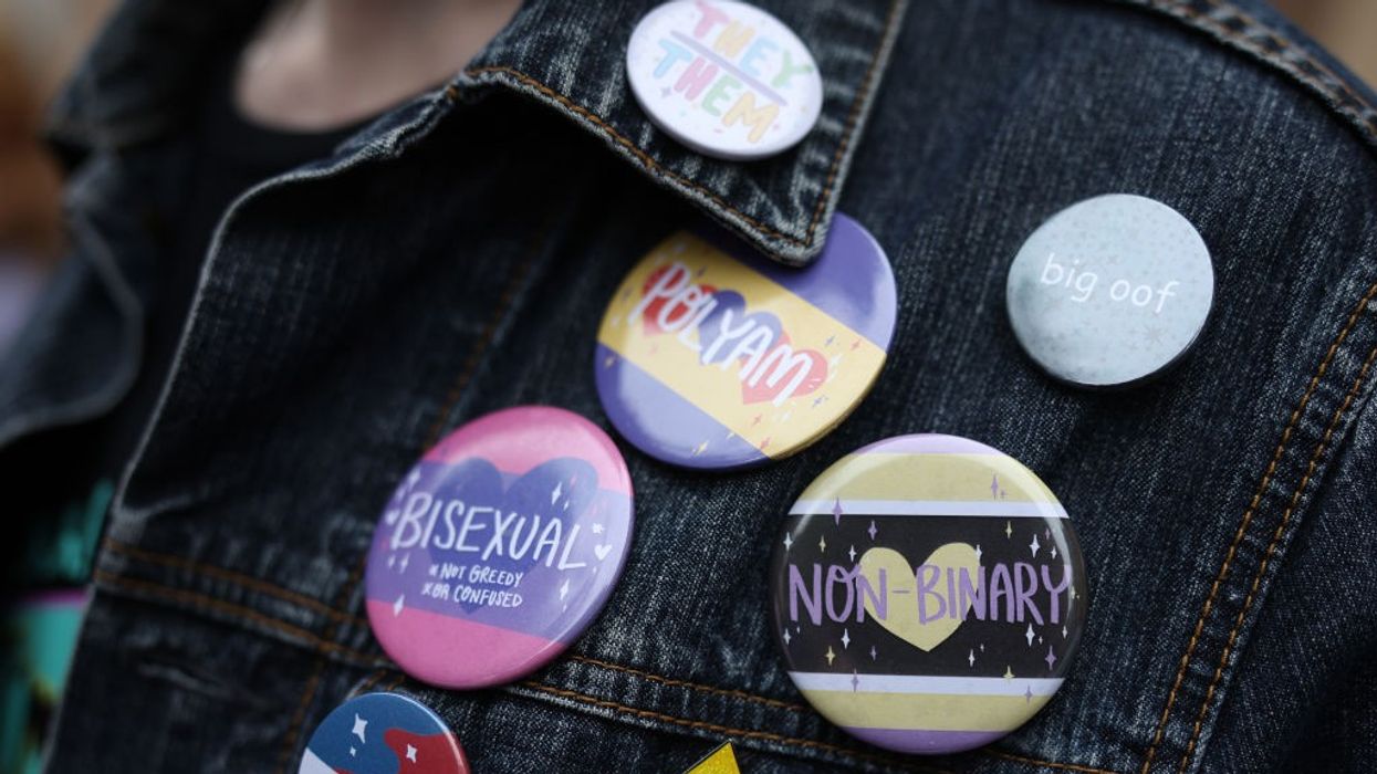 Girl with LGBT badges