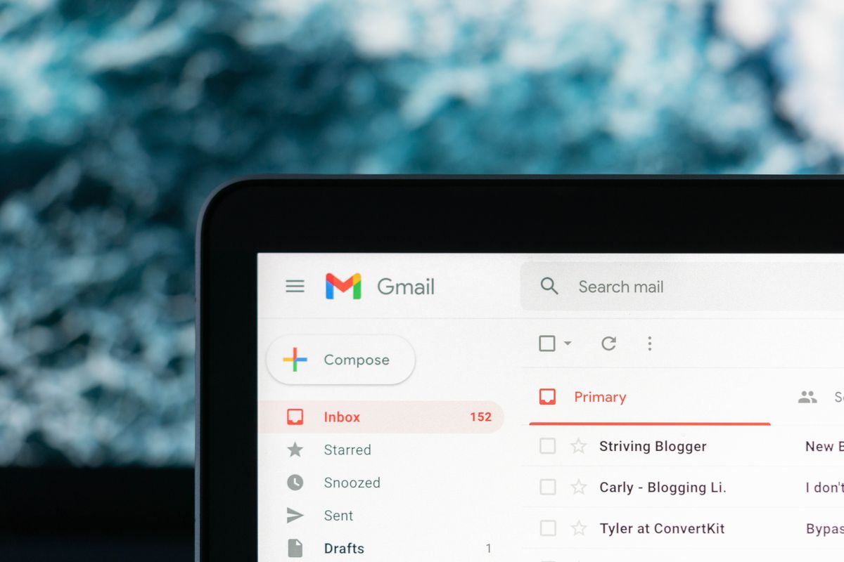 gmail inbox is pictured on-screen on a laptop with a blurred background