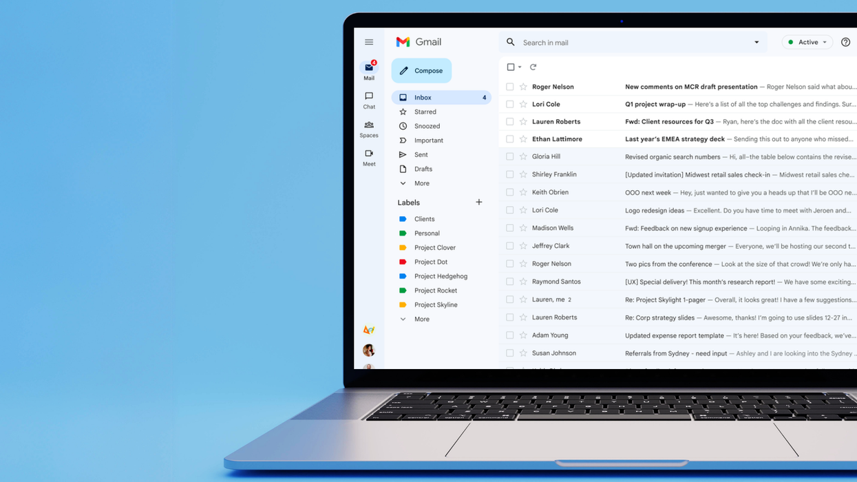 gmail inbox shown on-screen on a laptop with a blue background