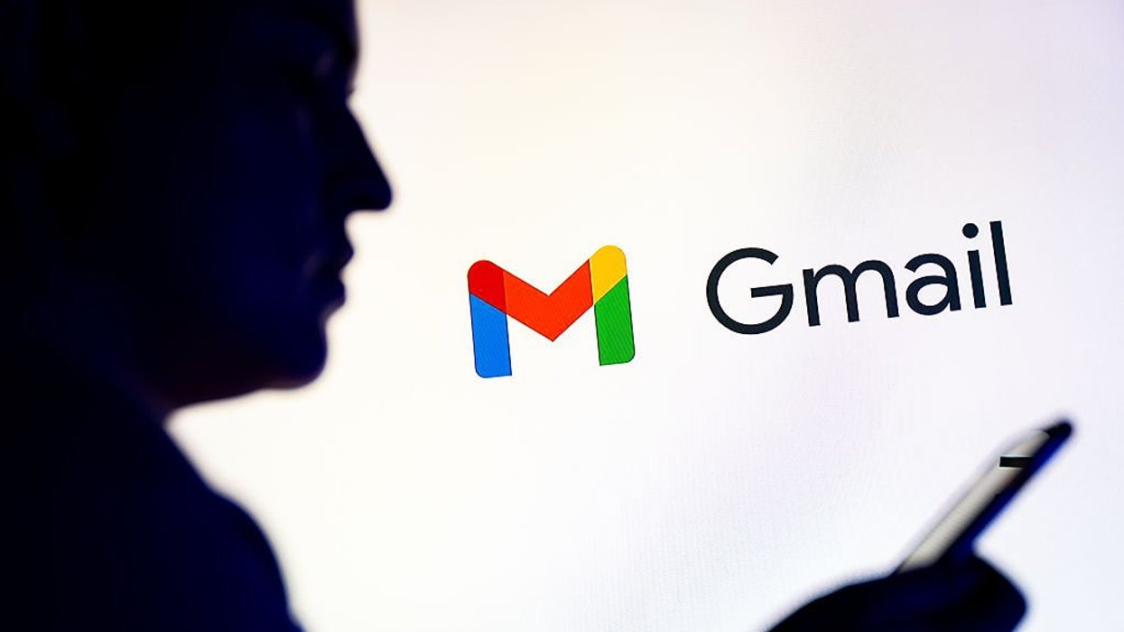 Gmail logo behind person holding handset