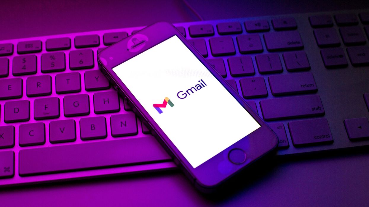 gmail logo pictured on-screen on an iphone laying on a keyboard