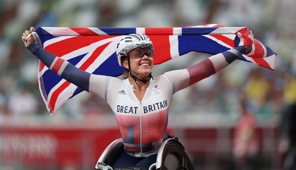 Gold Medallist Hannah Cockroft of Britain celebrates setting a new world record with the flag of Britain
