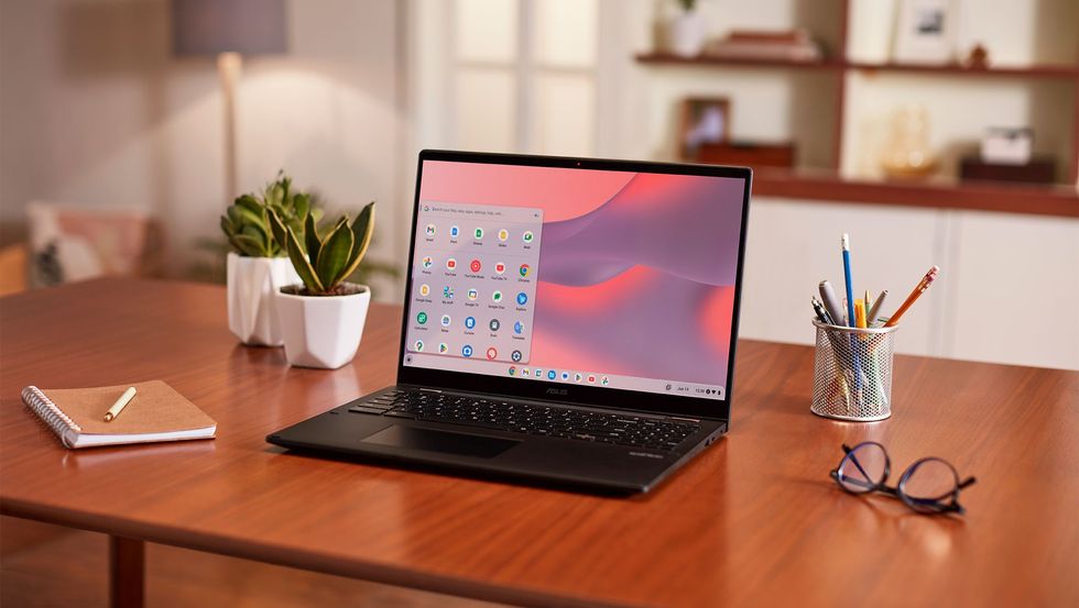 google chromebook pictured on a desk with pencils and pens scattered around