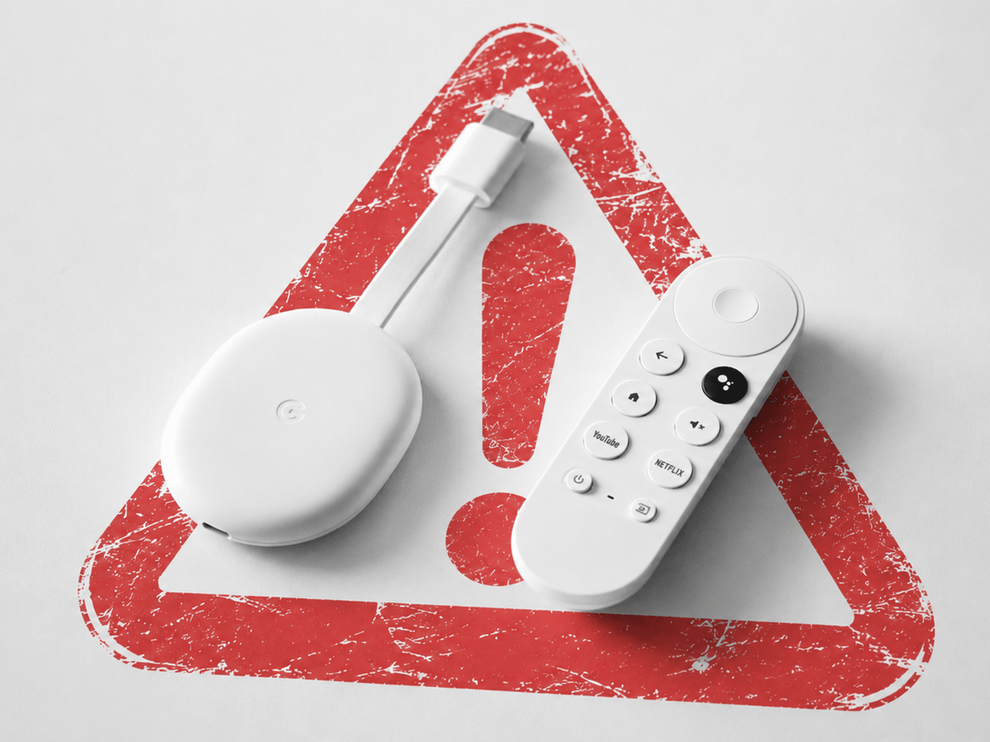 google chromecast shown on a table with a warning triangle in the background