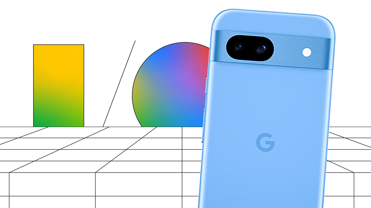 google io promotional image in the background with a pixel 8a phone pictured in the foreground