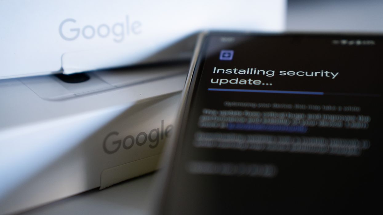 google pixel phone with security update installing on-screen with google branded boxes in the background