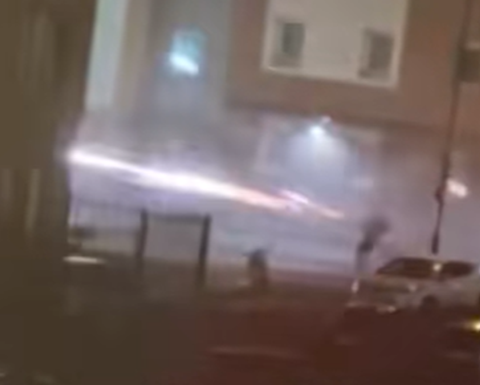 Grainy social media footage of a youth firing fireworks from their hands\u200b