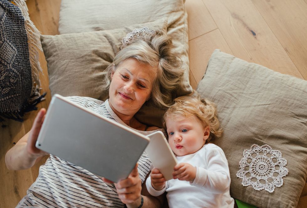 Grandmother and grandchild looking at screens