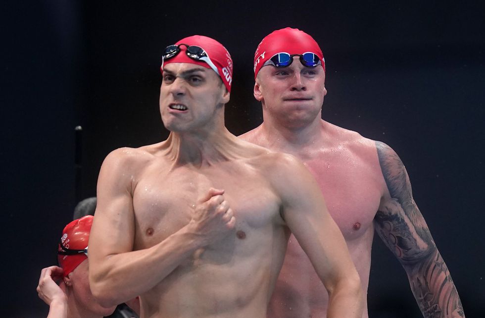 Great Britain's Adam Peaty and James Guy celebrate winning the Mixed 4100 metres medley relay during the swimming at the Tokyo Aquatics Centre on the eighth day of the Tokyo 2020 Olympic Games in Japan. Picture date: Saturday July 31, 2021.