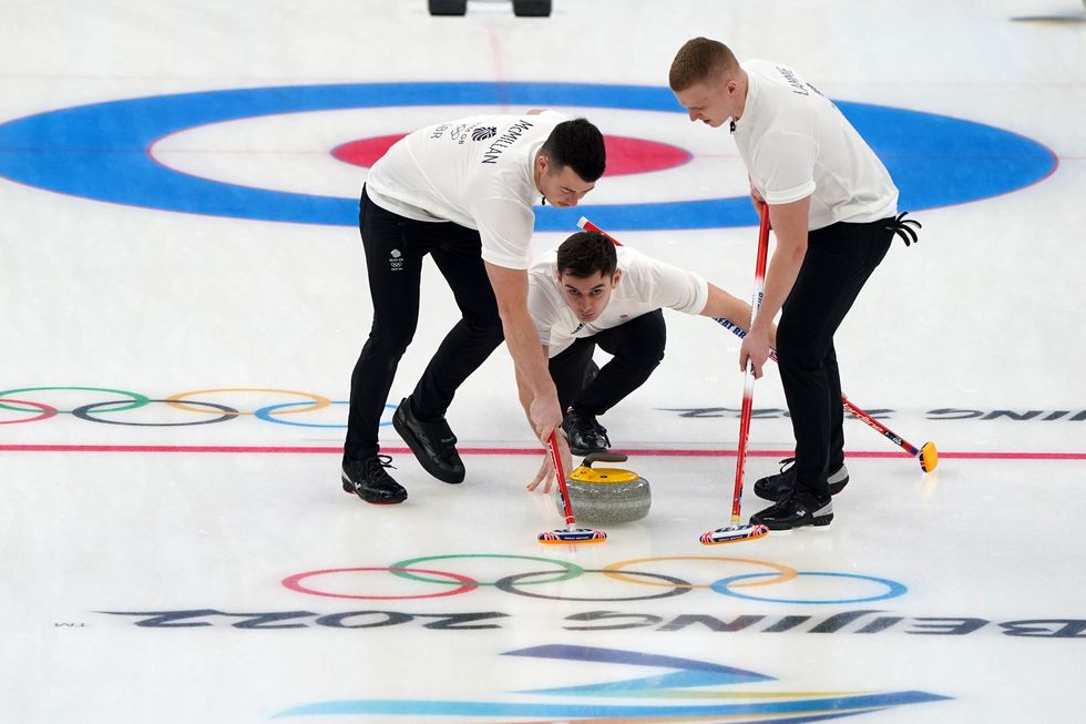 Great Britain's Grant Hardie launches a stone as Hammy McMillan and Bobby Lammie sweep during the Men's Gold Medal game
