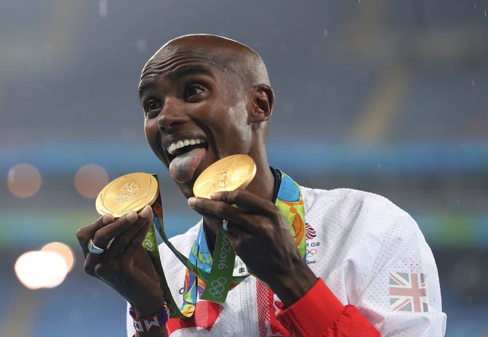 Great Britain's Mo Farah celebrates with his gold medals after winning the Men's 5000m and 10,000m at the Rio Olympic games