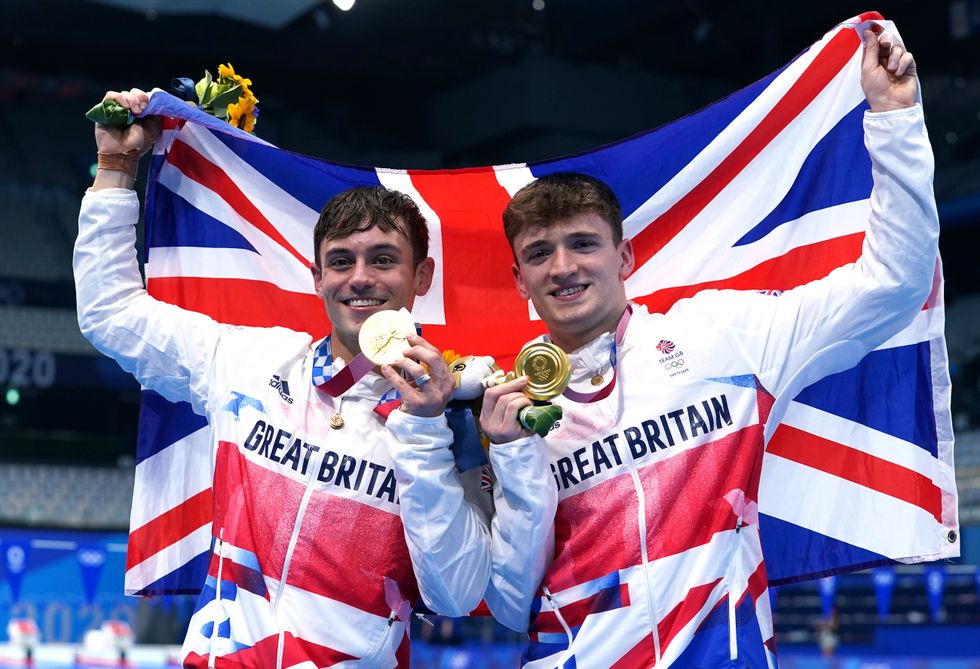 Great Britain's Tom Daley (left) and Matty Lee celebrate winning gold in the Men's Synchronised 10m Platform Final at the Tokyo Aquatics Centre on the third day of the Tokyo 2020 Olympic Games in Japan.