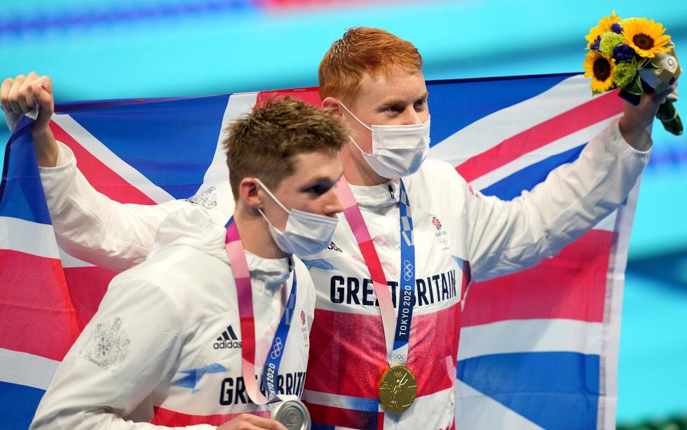 Great Britain's Tom Dean (right) with his gold medal celebrates after winning the Men's 200m Freestyle alongside second placed silver medalist Great Britain's Duncan Scott at Tokyo Aquatics Centre on the fourth day of the Tokyo 2020 Olympic Games in Japan.