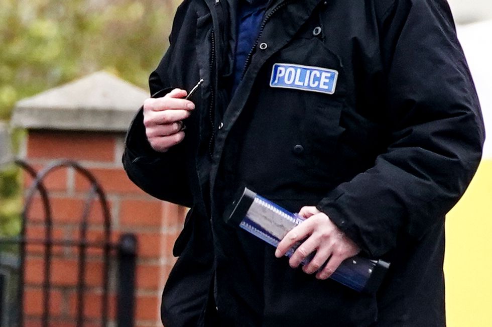 Greater Manchester Police officers searching for evidence at the scene have a knife in a plastic tube, on Thirlmere Avenue in Stretford, Manchester, after a 16-year-old boy, named by police as Kennie Carter, was fatally stabbed at around 7pm on Saturday. Picture date: Monday January 24, 2022.