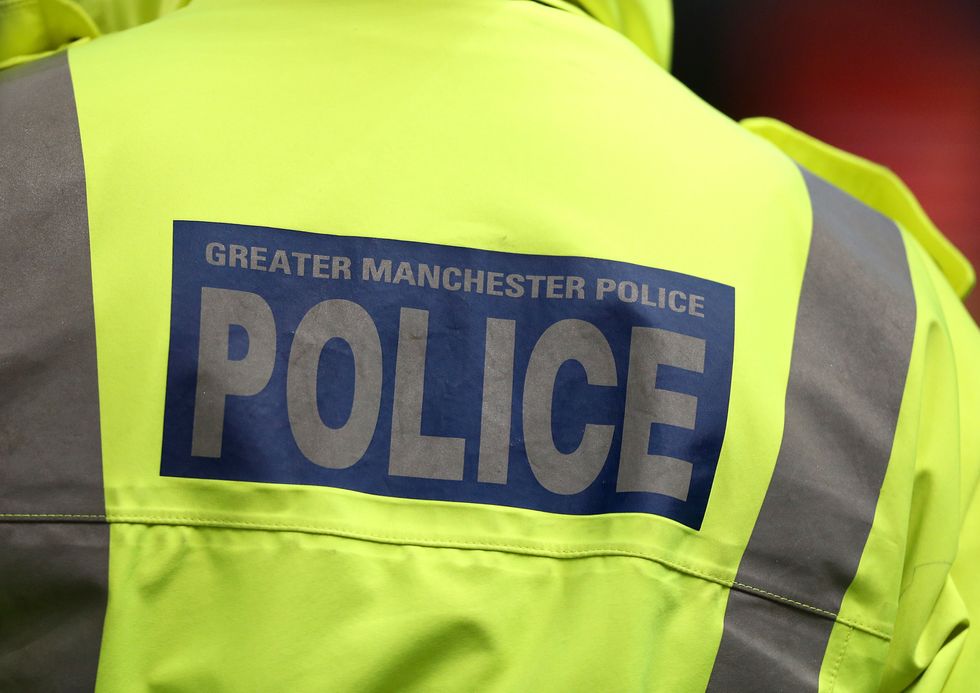 Greater Manchester Police signage on a policeman's jacket