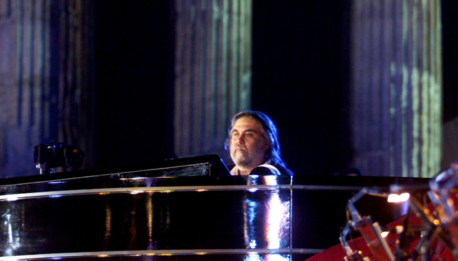 Greek composer Vangelis performs during a concert at the Temple of Zeus in Athens on June 28, 2001. Vangelis presented a 60-minute composition entitled Mythodea.