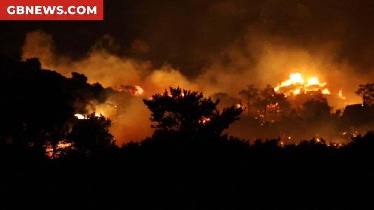 Tourists urgently evacuated as 'out of control' wildfires break out on popular Greek island
