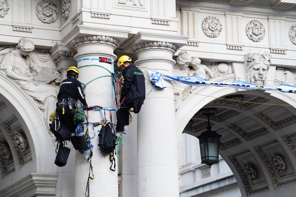 Greenpeace activists who have scaled the King Charles Street Archway,