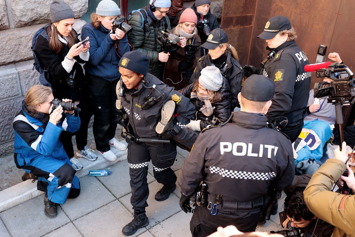 Greta Thunberg being carried away by police