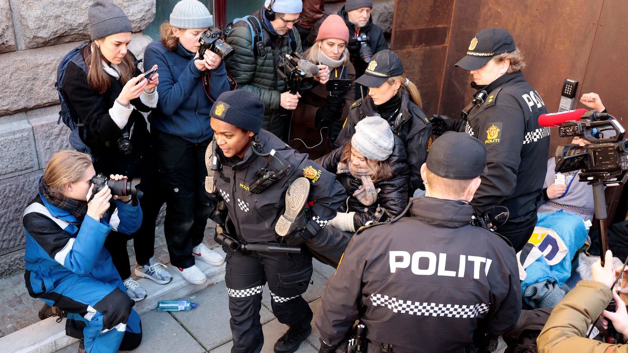 Greta Thunberg being carried away by police