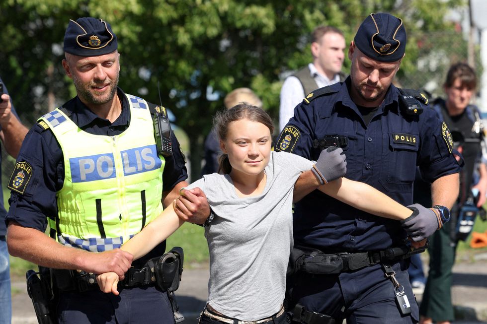 Greta Thunberg being escorted by police