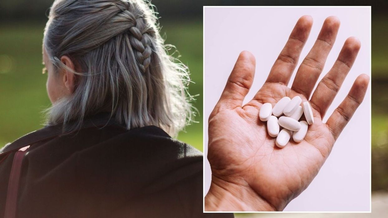grey hair and supplements in hand