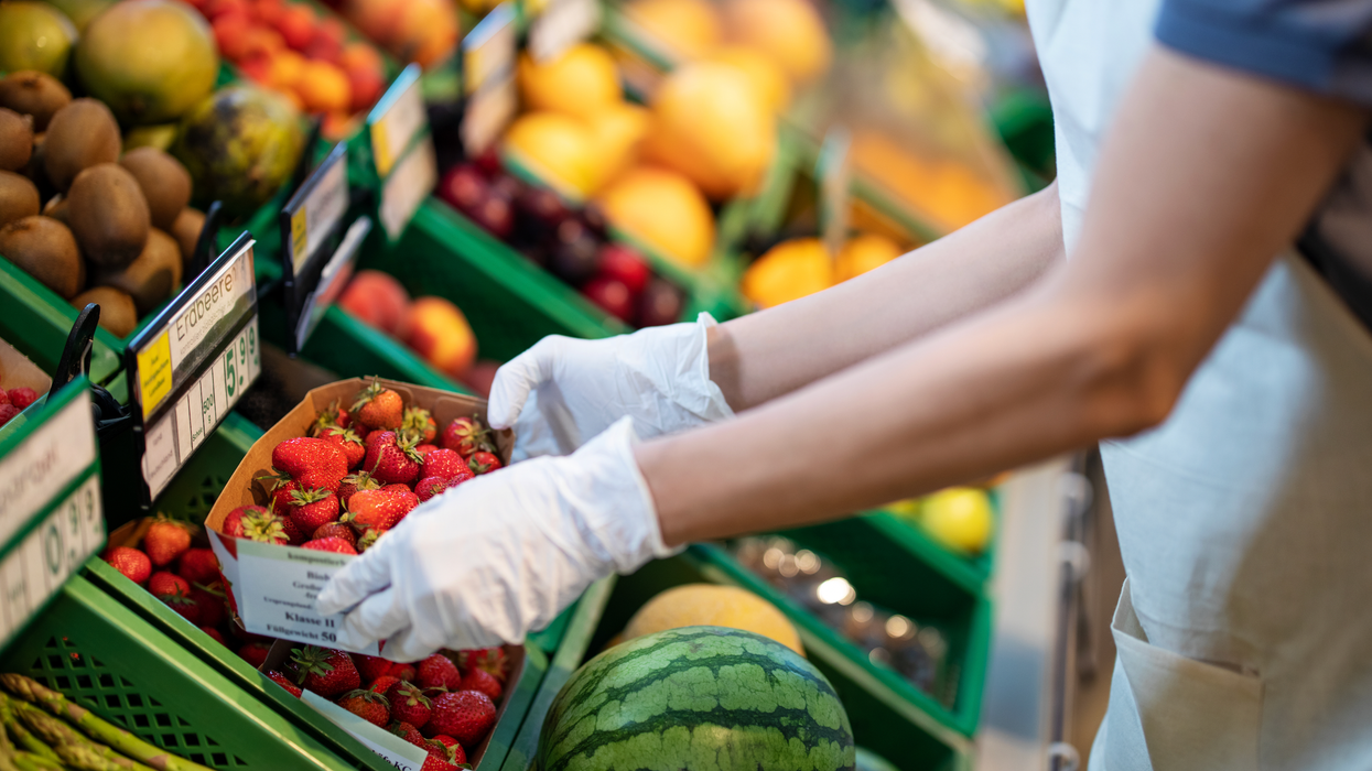 Grocer handling strawberries