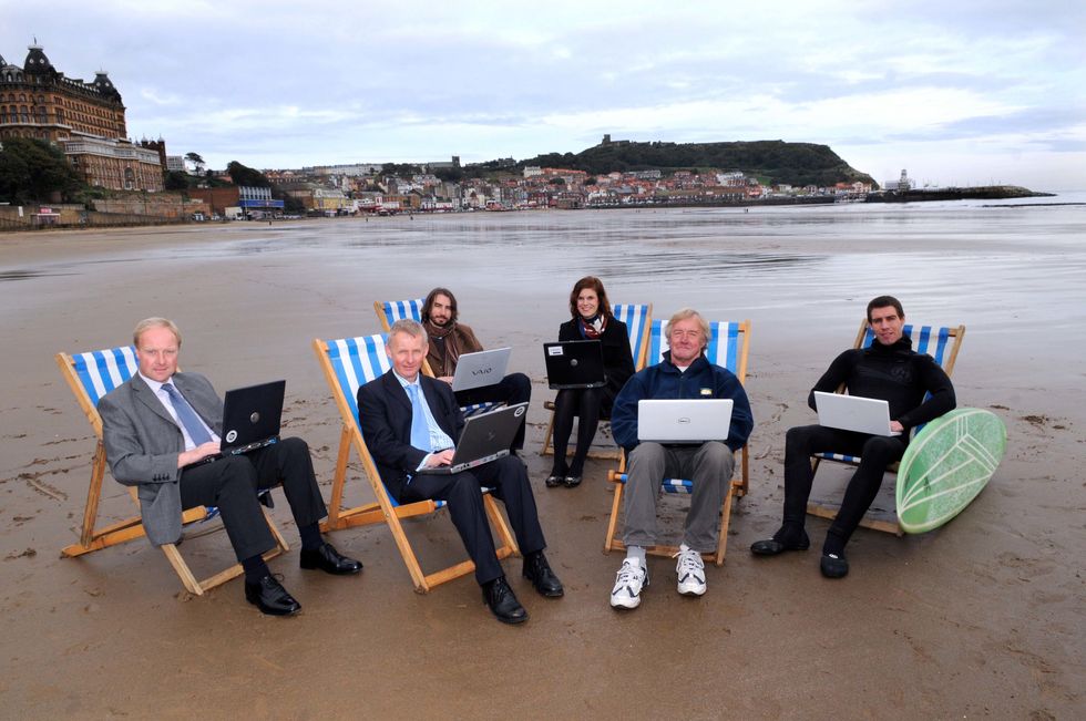 Group of men working from beach